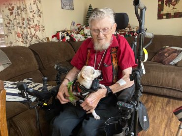 Lemoore's Jim Christian in his Lemoore home with his dog Daisy.